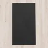 A black shower tray on a light wood floor. Produktbild-Vorschau