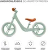 A mint green balance bike with a brown seat and handlebars, shown against a white background with feature icons below. Produktbild-Vorschau