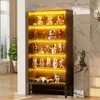 A display cabinet filled with various collectibles, illuminated by internal lighting. Náhľad obrázku produktu