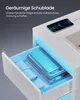 A white nightstand with an open drawer illuminated by blue LED lights, showing books and a rolled-up cloth inside. A smartphone is charging on top. Produktbild-Vorschau