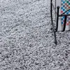 A close-up view of a gray shaggy carpet. Produktbild-Vorschau