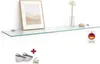 A glass shelf mounted on a white wall, with a framed picture, a vase with a flower, and a small stone on it. Also shows mounting brackets and screws. Produktbild-Vorschau