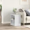 A white side table with books and a vase with a plant is placed next to a sofa in a well-lit room. Produktbild-Vorschau