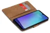 A book-style phone case with credit card slots, holding a smartphone. Náhled obrázku produktu