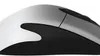 A close-up side view of a white and black computer mouse against a white background. Anteprima dell’immagine prodotto