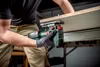 A person is using a cordless jigsaw to cut a piece of wood. Voir les images du produit