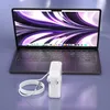 A laptop and its power adapter are displayed on a purple surface. Podgląd zdjęcia produktu