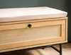 Close-up of a shoe bench with a cushioned seat and a rattan-fronted drawer. Voir les images du produit