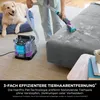 A person is using a Shark StainStriker carpet cleaner on a gray sofa, with a dog lying on a blue dog bed in the background. Podgląd zdjęcia produktu
