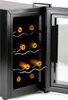 A black wine cooler with the door open, showing several bottles of wine on wire racks inside. Voir les images du produit