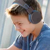 A young boy wearing headphones and smiling. Produktbild-Vorschau