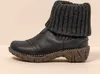 A single black boot with a gray knitted cuff is shown against a light gray background.
