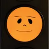 A close-up of an orange LED light with a smiley face drawn on it, set against a black background. Voir les images du produit
