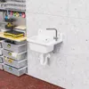 A utility sink and storage bins are shown in a garage or workshop setting. Produktbild-Vorschau
