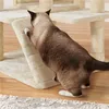 A cat is climbing on a beige cat tree. Podgląd zdjęcia produktu