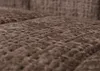 A close-up, angled view of a brown textured fabric, likely upholstery. Podgląd zdjęcia produktu