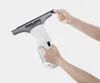 Hands holding and demonstrating a Kärcher WV 1 electric window cleaner. Voir les images du produit