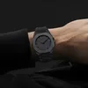 A person's wrist wearing a black watch. Produktbild-Vorschau