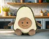 A plush avocado toy sits on a wooden table in a kitchen setting. Anteprima dell’immagine prodotto