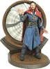 A Doctor Strange action figure standing on a circular base in front of a large, circular clock-like structure. Náhľad obrázku produktu