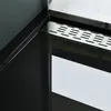 A close-up view of a modern black shower tray with a silver drain grate. Produktbild-Vorschau