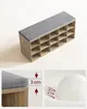 A shoe bench with storage compartments and a cushioned top. Produktbild-Vorschau
