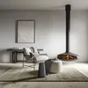 A modern living room with a fireplace, chair, and speaker. Produktbild-Vorschau