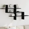 A black wooden wall shelf with various decorative items placed on it, mounted on a white wall above a sofa. Podgląd zdjęcia produktu