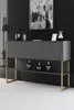 A modern console table with gold legs and an anthracite top, displayed in a room with a black slatted wall and abstract art. Podgląd zdjęcia produktu