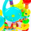 A close-up view of a colorful marble run toy with several glass marbles visible. Produktbild-Vorschau