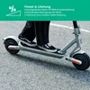 A person riding an electric scooter on a paved surface. Produktbild-Vorschau