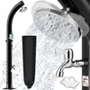 A black outdoor shower with water spraying from the showerhead and a black protective cover. Produktbild-Vorschau