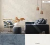 A living room scene with furniture and wallpaper samples, showcasing different color options and a floral pattern. Podgląd zdjęcia produktu