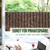 A balcony scene with a privacy screen, white bedding, a laptop, a book, and a glass of wine. Anteprima dell’immagine prodotto
