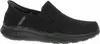 A black slip-on shoe is shown from the side against a white background. Voir les images du produit