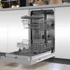An open dishwasher with its racks pulled out, showing the interior. Produktbild-Vorschau