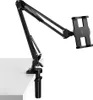 A black adjustable desk mount holder for a tablet or phone, clamped to a white desk. Podgląd zdjęcia produktu