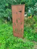 A decorative metal screen with cutouts of plants and butterflies, standing in a grassy outdoor area. Náhled obrázku produktu