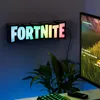 A Fortnite RGB logo lamp is mounted on a wall above a computer monitor and a plant. Anteprima dell’immagine prodotto