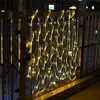 String lights are attached to a balcony railing at night. Produktbild-Vorschau