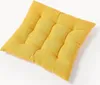 A yellow tufted seat cushion is shown from a diagonal angle against a white background. Produktbild-Vorschau