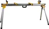 A Dewalt DE7023 Universal Untergestell zusammenklappbar (folding stand) is shown against a white background. Náhled obrázku produktu