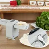 A close-up shot of an electric dumpling maker on a wooden table, with ingredients and finished dumplings visible. Produktbild-Vorschau