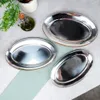 Three oval serving platters are arranged on a light gray and white surface, with a sprig of greenery and a small bottle of olive oil in the background. Produktbild-Vorschau