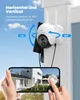 A security camera is mounted on a white pillar, with arrows indicating its rotation capabilities. A smartphone displays a live feed from the camera, showing a house and yard. Náhled obrázku produktu