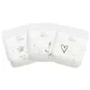 Three Eco by Naty diapers are arranged diagonally against a white background. Podgląd zdjęcia produktu