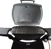 A close-up view of a Weber Q300/3000 series grill with the lid open, showing the cooking grates. Náhľad obrázku produktu