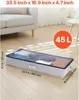 A storage box filled with clothes is placed on a wooden floor next to a sofa. Náhled obrázku produktu