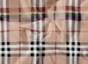 A close-up, flat lay of a beige fabric with a plaid pattern. Náhľad obrázku produktu