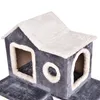 A close-up view of a grey and white cat tree with a house-like structure and openings. Produktbild-Vorschau